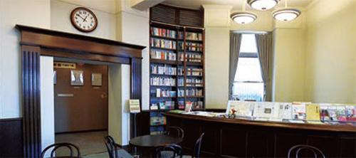 右側には円状の茶色いカウンター、左側には門の様な形をした出入り口のある文芸館の室内の写真