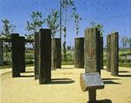 断面がカマボコ形になっているものやU字形になっている木柱がサークル配置されているチカモリ遺跡公園の写真