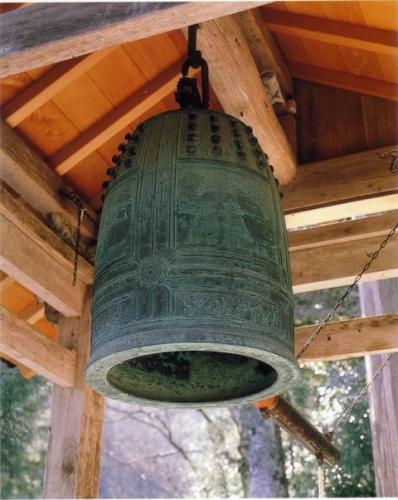 青銅色の宝乗寺梵鐘が鐘楼に吊り下げいるの下から写した写真