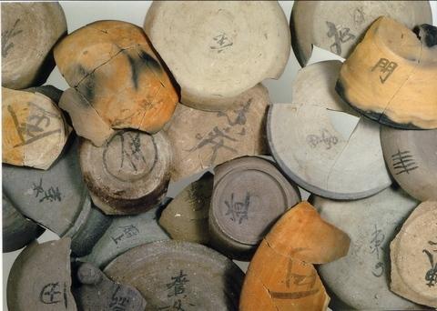 割れたり、掛けてしまっている皿の裏に「金」「仲」「道」などの文字が記され、色々な種類の皿が沢山並んでいる上荒屋遺跡出土品の墨書土器の写真
