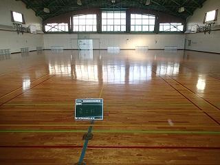 左右にバスケットゴールが設置されている工事前の体育館内の写真
