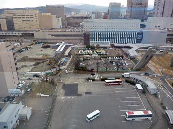 平成24年4月の工事進捗、北西から撮影した写真。左奥の駐車場に重機が入り工事をしている。